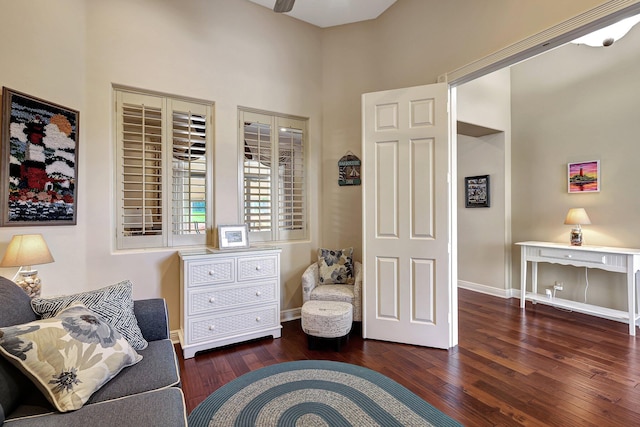 living room with ceiling fan and dark hardwood / wood-style flooring