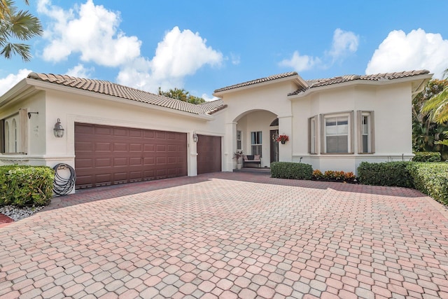 mediterranean / spanish house with a garage