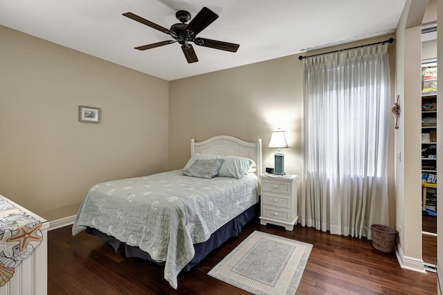 bedroom with dark wood-type flooring and ceiling fan