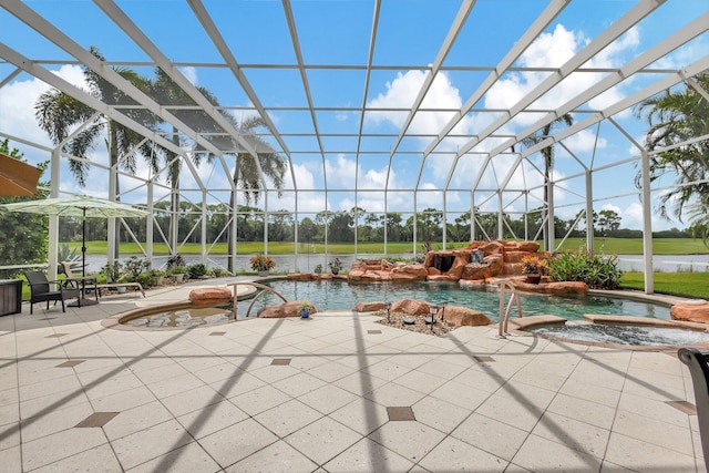 view of pool with a patio area, a hot tub, glass enclosure, pool water feature, and a water view