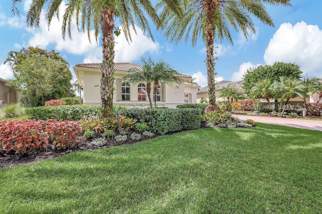 mediterranean / spanish house featuring a front lawn