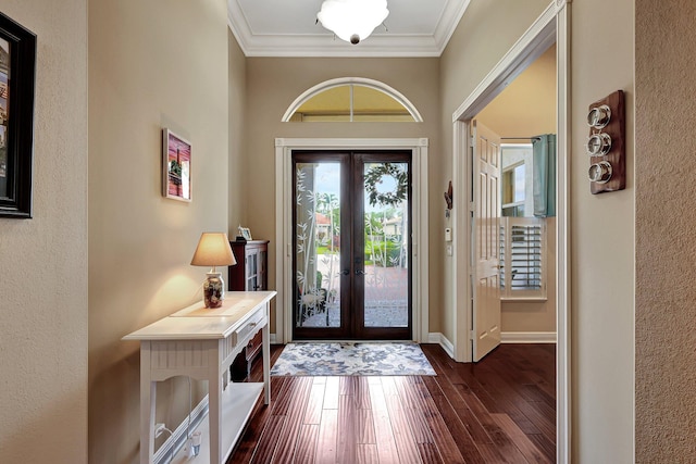 foyer entrance featuring french doors, crown molding, and dark hardwood / wood-style flooring