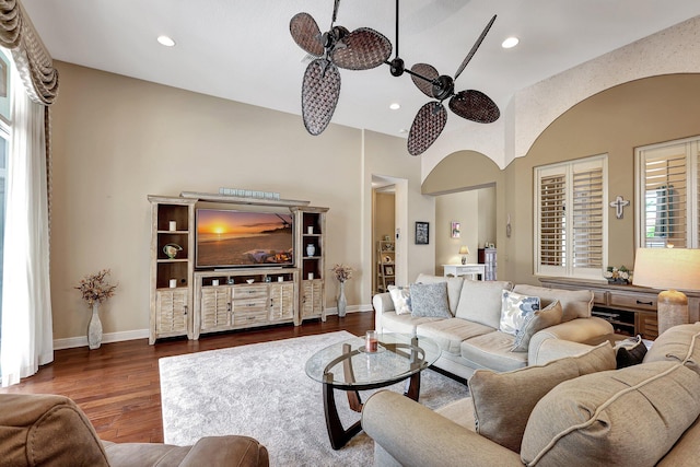 living room with ceiling fan and dark hardwood / wood-style flooring