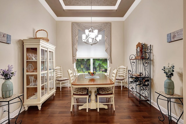 dining room featuring a tray ceiling, dark hardwood / wood-style flooring, and an inviting chandelier