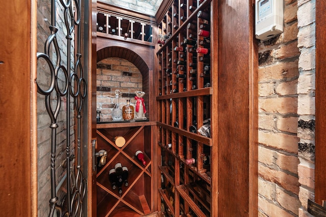 wine room featuring brick wall