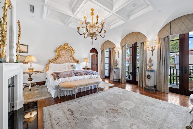 bedroom with crown molding, dark wood-type flooring, access to outside, and coffered ceiling