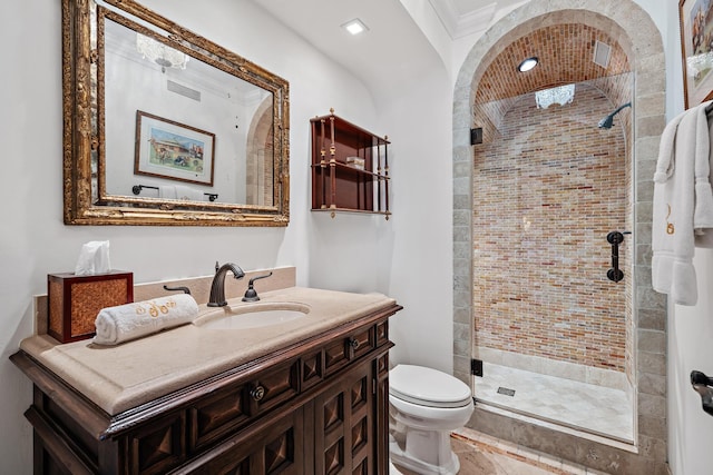 bathroom with crown molding, a shower with door, vanity, and toilet