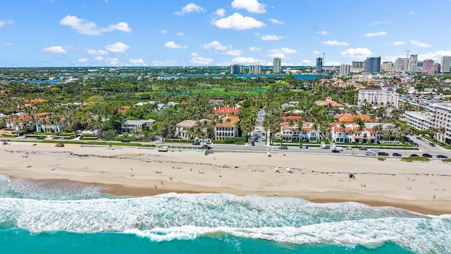 birds eye view of property featuring a water view and a beach view