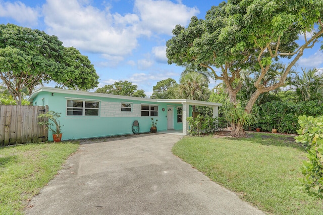 single story home with a carport and a front lawn