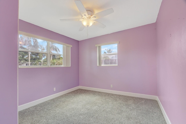 unfurnished room featuring a healthy amount of sunlight, carpet, and ceiling fan