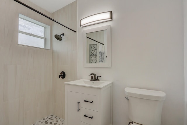 bathroom featuring walk in shower, vanity, and toilet