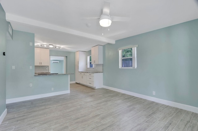 unfurnished living room with light wood-type flooring and ceiling fan