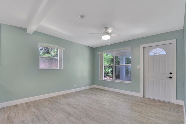 foyer entrance with light wood-type flooring, beam ceiling, and ceiling fan