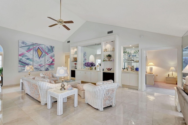 tiled living room featuring ceiling fan and high vaulted ceiling