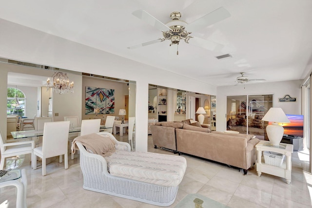 living room with ceiling fan with notable chandelier