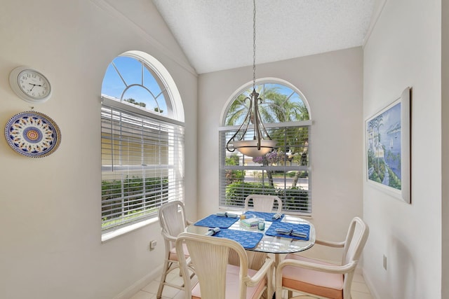 dining space with a textured ceiling, a healthy amount of sunlight, and light tile patterned floors