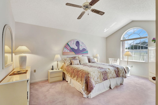 bedroom featuring a textured ceiling, lofted ceiling, light carpet, and ceiling fan