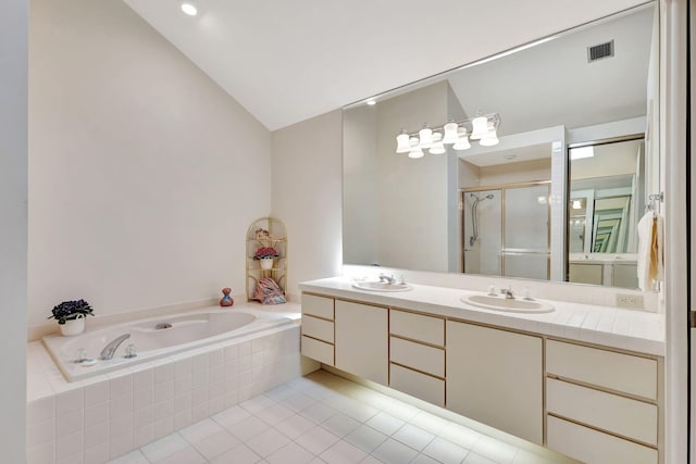 bathroom featuring vanity, lofted ceiling, shower with separate bathtub, and tile patterned floors