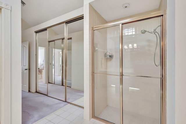 bathroom featuring tile patterned flooring and a shower with door