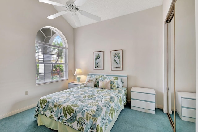 bedroom with ceiling fan, lofted ceiling, a closet, and carpet