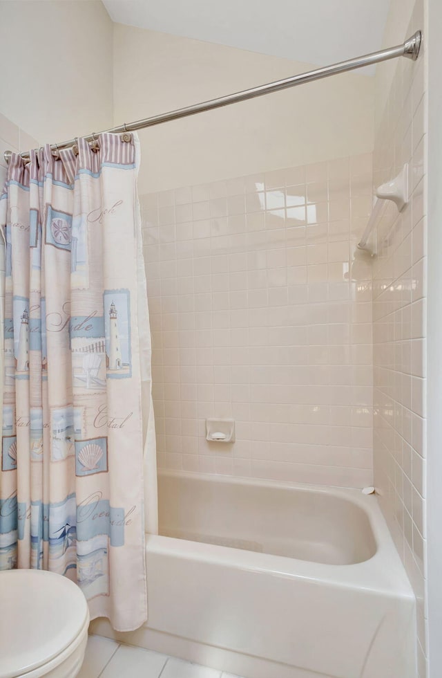 bathroom featuring shower / bath combination with curtain, tile patterned flooring, and toilet