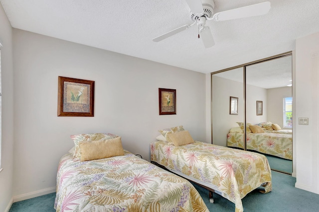 carpeted bedroom featuring a closet, ceiling fan, and a textured ceiling