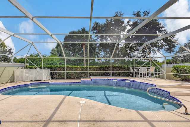 view of pool with a lanai and a patio area