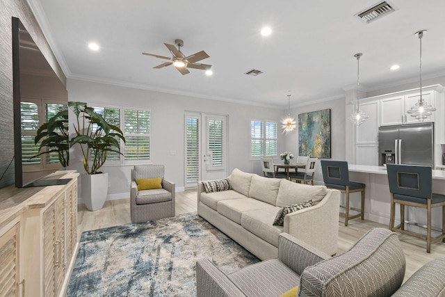 living room with ceiling fan, ornamental molding, and light wood-type flooring