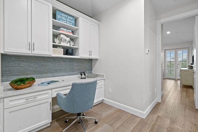 office featuring built in desk and light hardwood / wood-style flooring