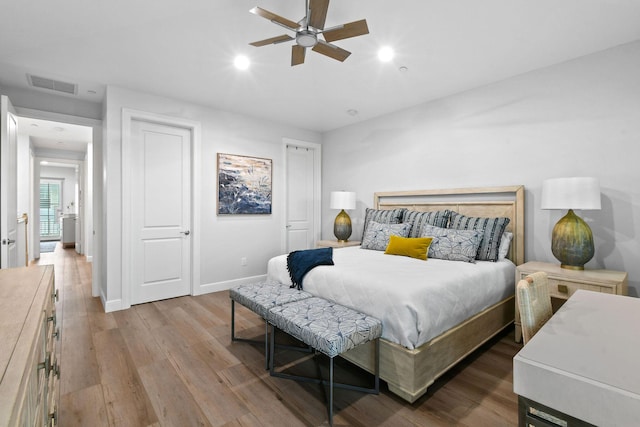 bedroom with ceiling fan and light wood-type flooring