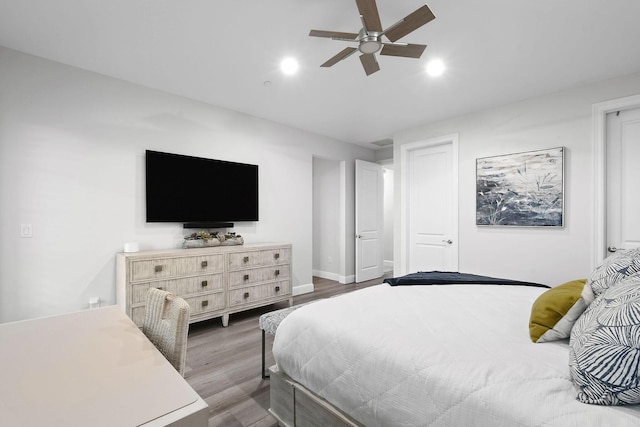 bedroom with ceiling fan and dark hardwood / wood-style floors