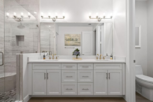 bathroom featuring vanity, toilet, and walk in shower