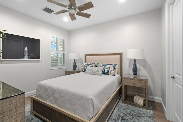 bedroom with ceiling fan and dark hardwood / wood-style flooring