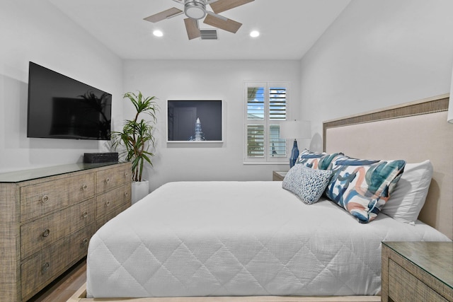 bedroom with ceiling fan and light hardwood / wood-style floors