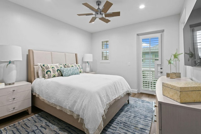 bedroom with ceiling fan and dark hardwood / wood-style flooring