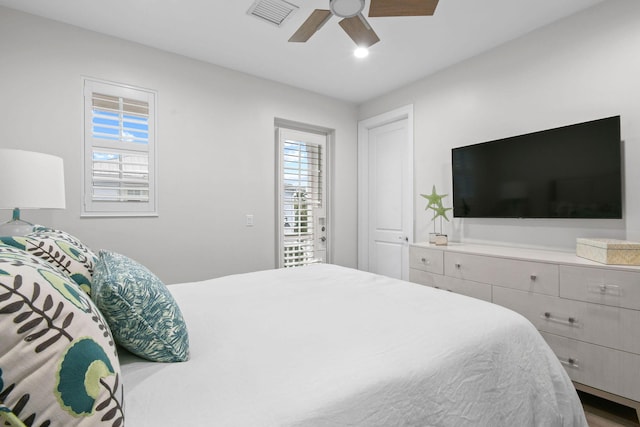 bedroom with ceiling fan and multiple windows