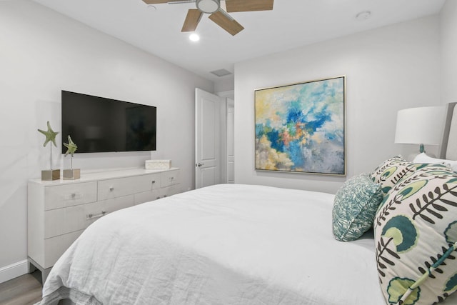 bedroom with ceiling fan and wood-type flooring