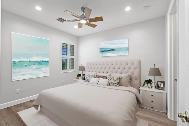 bedroom with light hardwood / wood-style floors and ceiling fan