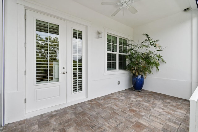 view of exterior entry with ceiling fan