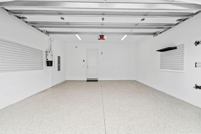 garage featuring electric panel and a garage door opener