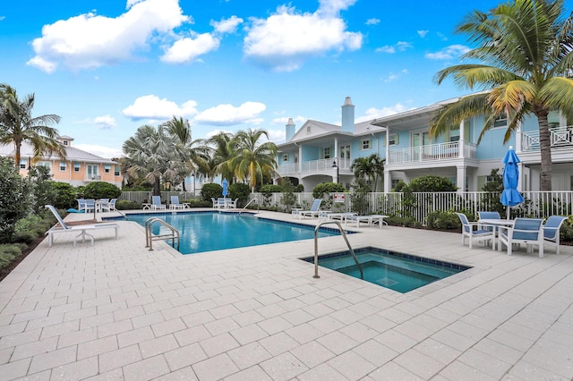 view of pool featuring a patio area and a community hot tub