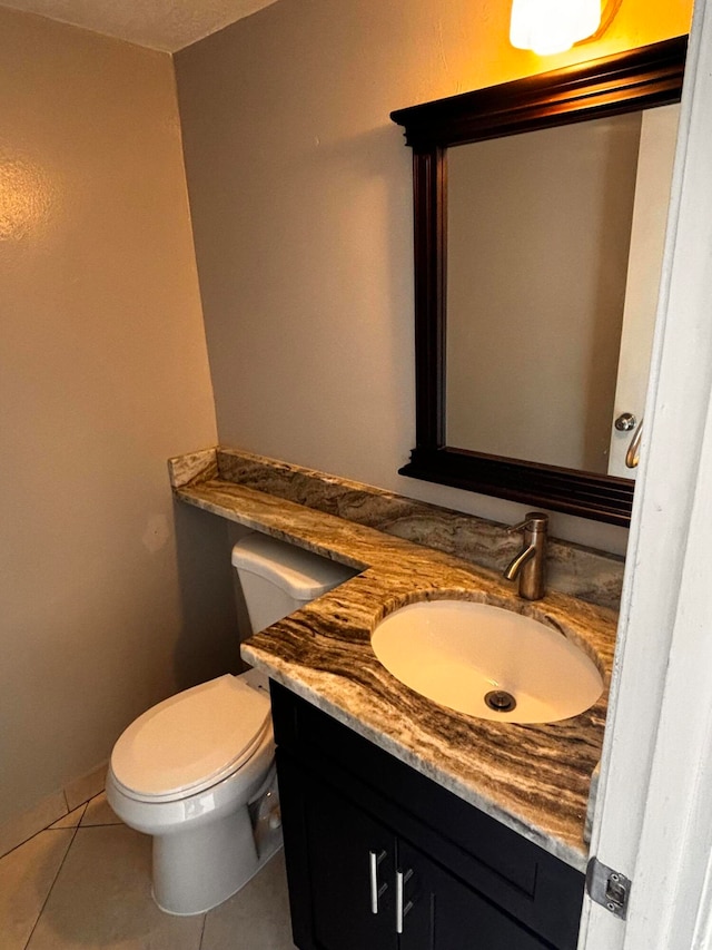 bathroom featuring tile patterned flooring, vanity, and toilet