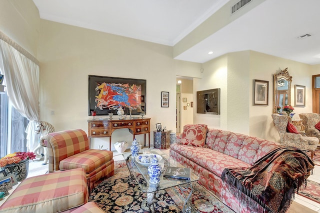 living area with ornamental molding, recessed lighting, and visible vents