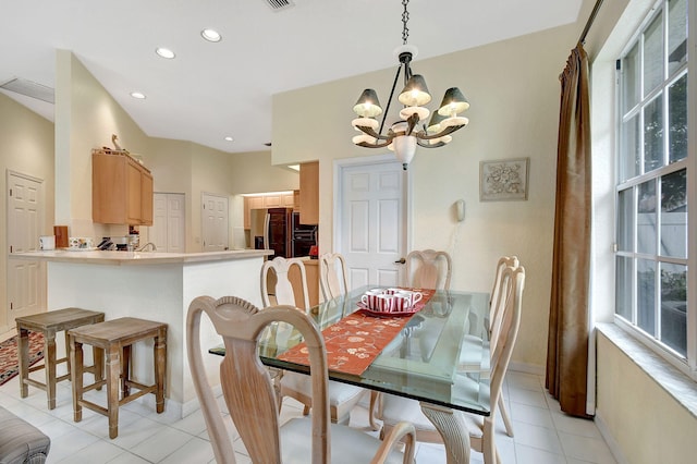 dining room with an inviting chandelier and light tile patterned flooring