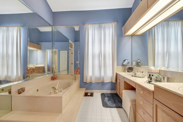 full bathroom featuring a tub with jets, tile patterned flooring, double vanity, and baseboards