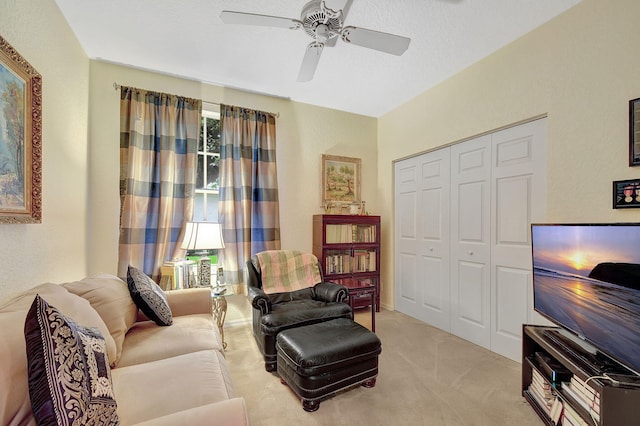 living area with carpet flooring and ceiling fan