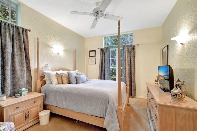 bedroom featuring ceiling fan and light carpet