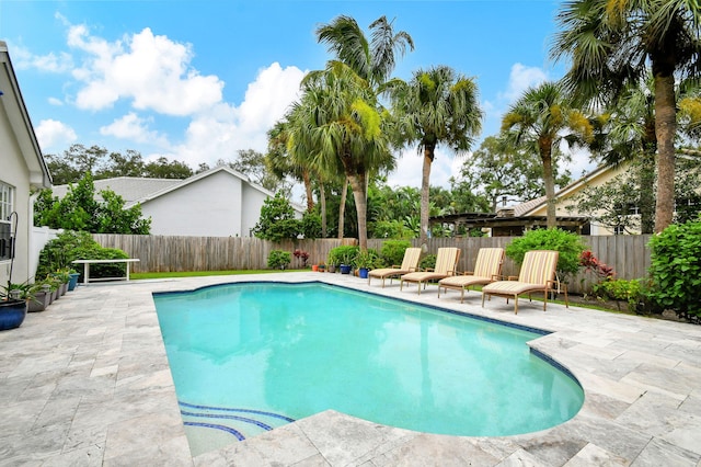 view of pool featuring a fenced in pool, a fenced backyard, and a patio area