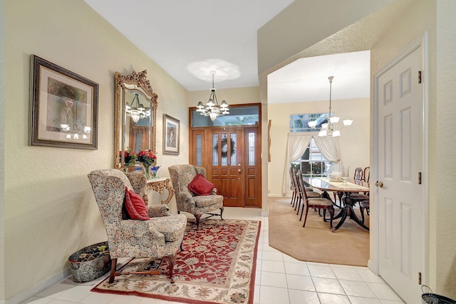 foyer with baseboards, an inviting chandelier, and light tile patterned flooring
