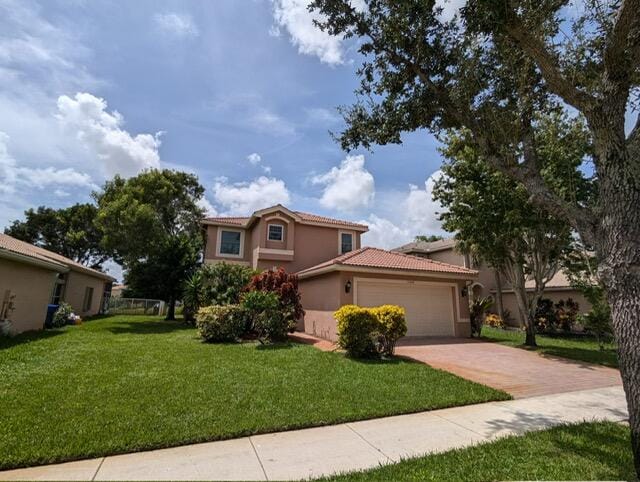 view of front of property with a garage and a front yard